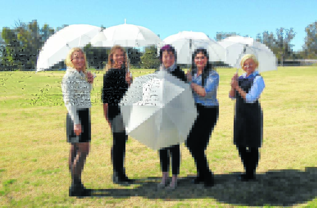 GUNNEDAH GO: White Ribbon women, from left, Kelly Donnelly and Krysten Barros (from K&K), world record attempt organiser Debra Hilton, Fonda Blackwell from Gunnedah Shire Council and Lisa Davies of Gunnedah PRAMS, are leading the way in the brolly brigade.