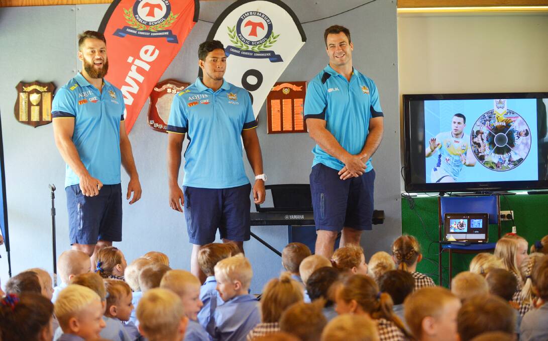Titans trio (from left) Matt Robinson, Oshae Tuiasau and Dave Shillington answering plenty of questions from their young  Timbumburi students yesterday. Photo: Barry Smith 040216BSA03
