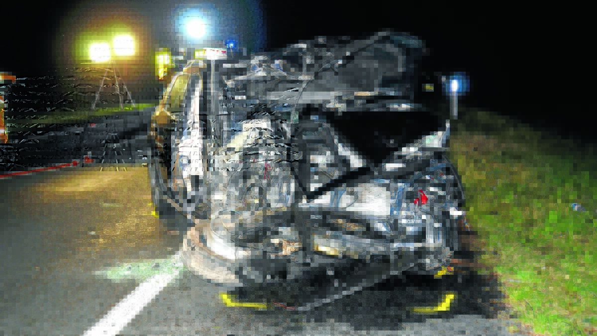 FATAL CRASH: The wreckage of one of the cars at the scene of the collision on the New England Highway on Monday.