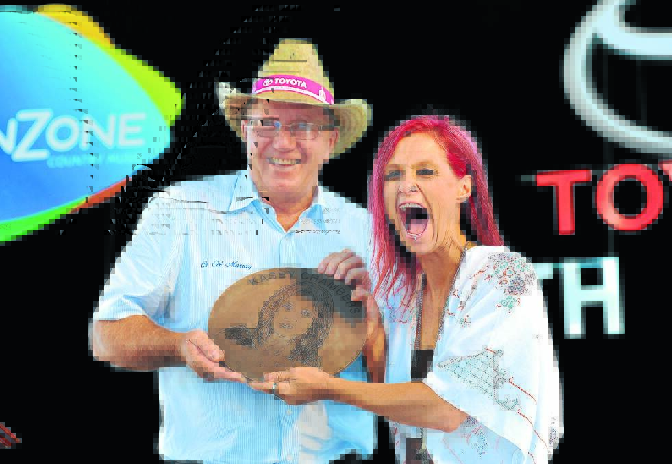 HOT STUFF: She’s the queen of cool, but Kasey Chambers was blown away with her newest gong in Tamworth yesterday. Mayor Col Murray inducted the songstress into the Galaxy of Stars, joining many other industry immortals. Photo: Paul Mathews 20116PMD25