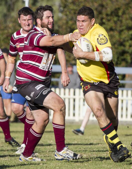 Inverell’s Alex McCosker grabs at Moree’s Mundarra Weldon during Sunday’s major semi-final. Weldon was a standout for the Boomerangs in their six-point win. Photo: John Hamiton