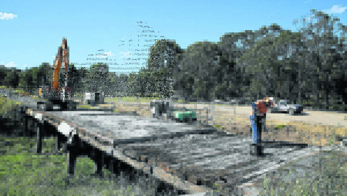 GOING, GOING, GONE: External contractors dismantle the existing timber bridge over Toms Gully, north-west of Armidale.