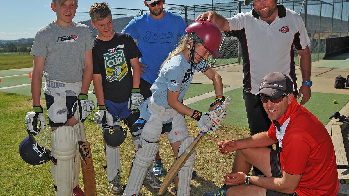 Talented Central North girls cricketer Lara Graham shows Brendan Lyon (right)  the full face of her bat as Nathan Watts, Jackson Kent, Nathan Lyon and Mark McInnes admire the schoolgirl’s impressive technique.Photo: Geoff O'Neill  240914GOE01