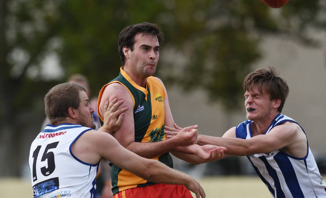 Moree Suns’ Daniel Kearney is sandwiched by a pair of Tamworth Kangaroo Matts – Matt Hodge (left) and Matt Hughes  – during Saturday’s TAFL  demolition at No 1 Oval. The Roos won by 144 points. Photo: Gareth Gardner 300416GGE01