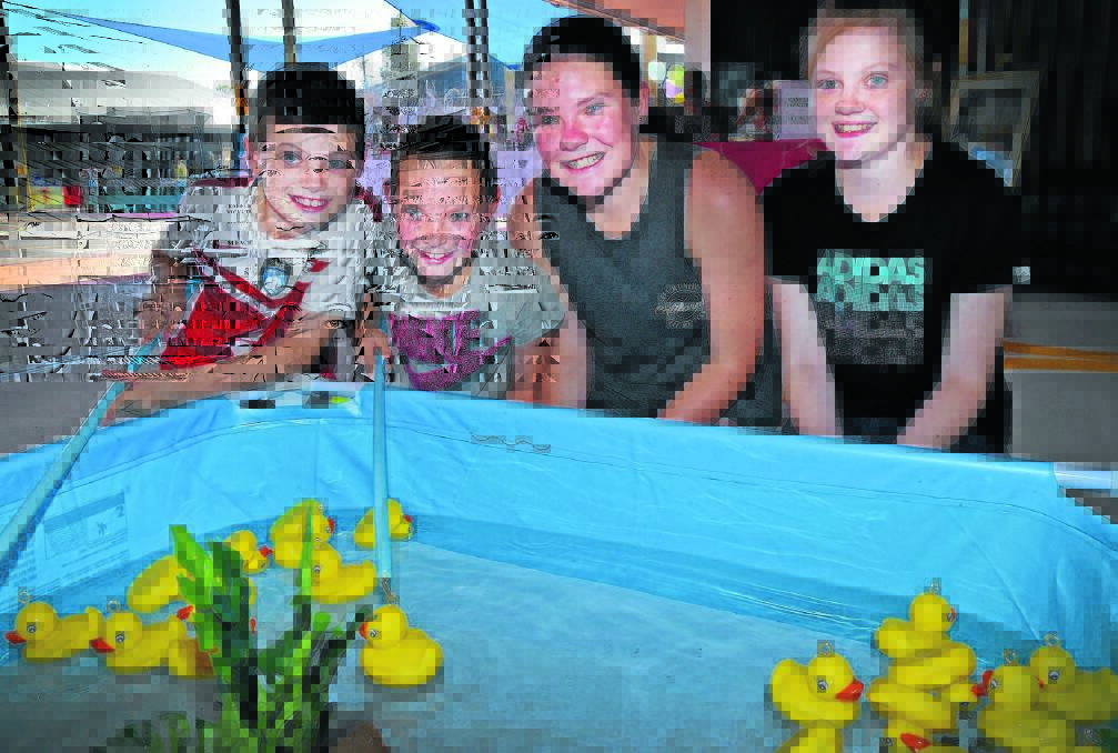 FISHING FOR BARGAINS: Zander Pearson, Jordan Donnelly, Tanisha Donnelly and Lara Pearson enjoyed the fun of the fair. Photo: Geoff O’Neill 211115GOG01