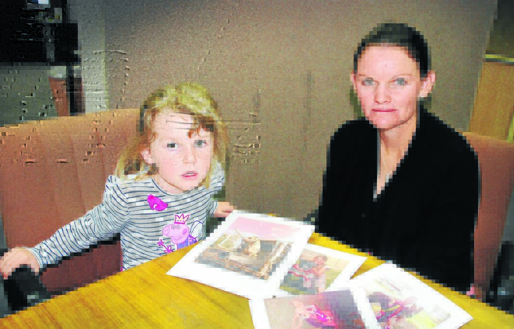 MISSING PETS: Charlotte and mum, Nicole Gillogly, with photos of their beloved pets, who they want returned to them, and are offering a reward. 200815RBA02
