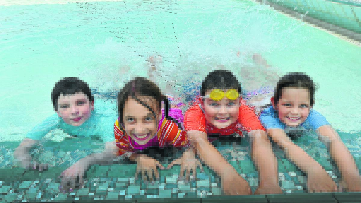 COOLING OFF: Hayden Stokes, Emily Driscoll, Taleela Wynne and Jesse Sylvester of Oxley Vale Public School enjoyed a swim at Scully Pool during the heat on Friday. Photos: Geoff O’Neill 201115GOD01