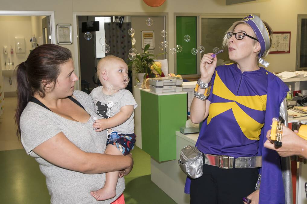 MOOD LIFTER: Kirby and Riley Eveligh with Captain Starlight at the Tamworth Hospital Children's Ward on Wednesday. Photo: Peter Hardin 210318PHB020