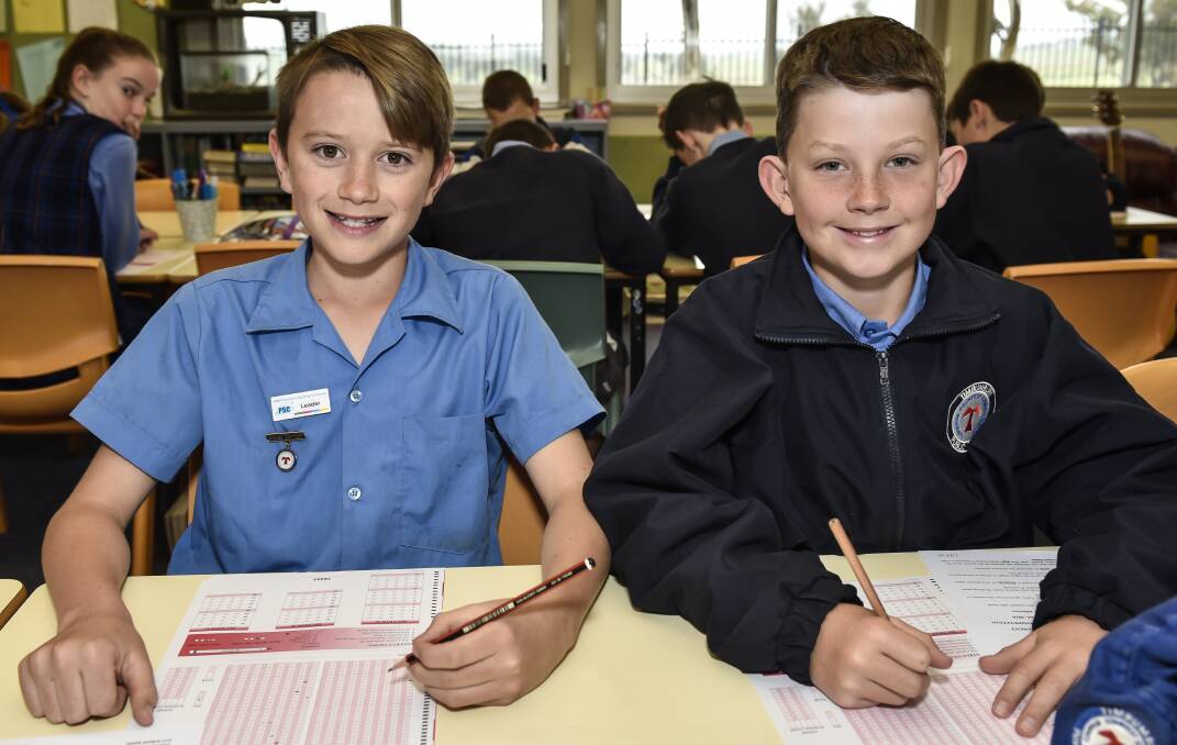 MATHS TASKS: Ty Purcell and Joseph Briggs put their minds to the test. 240816PHA10
