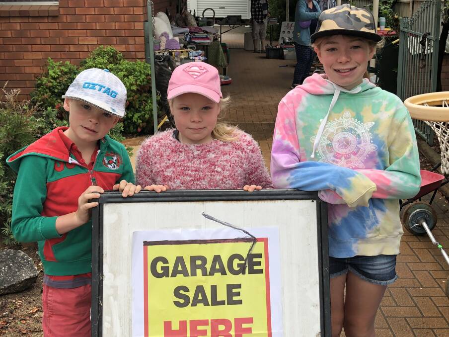 POCKET MONEY: Mitchell, Emma and Abigail Taggart held their own garage sale for some extra cash. Photo: Haley Craig