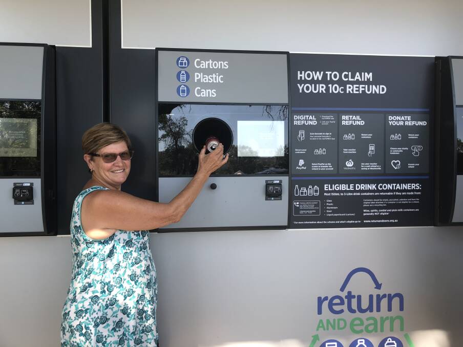 UP AND RUNNING: Festival camper Glenda Riley tests out the new temporary Return and Earn machine at the Carter St sporting fields camping site. Photo: Haley Craig 