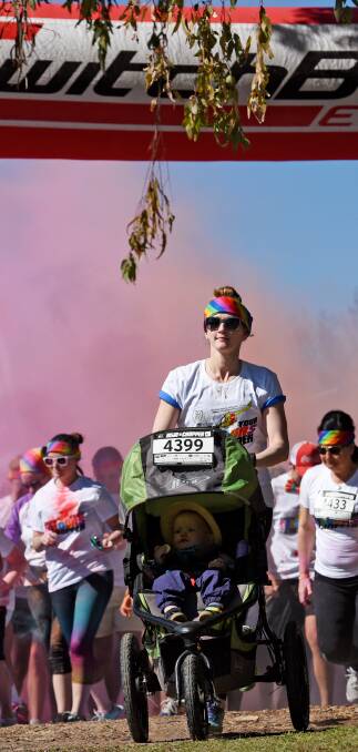 COLOUR BURST: Runners were covered in a sea of colour at Sunday's event. 310716GGD40