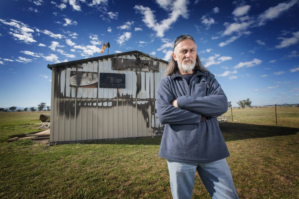 REBUILD: Club president Larry Hoskins outside the shed that was completely gutted by fire last month. Photo: Peter Hardin 