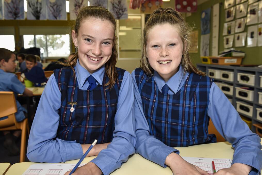 COMPETITION: Timbumburi students Ella Constable and Izzy Bramley put pen to paper for the big test on Wednesday. 240817PHA14