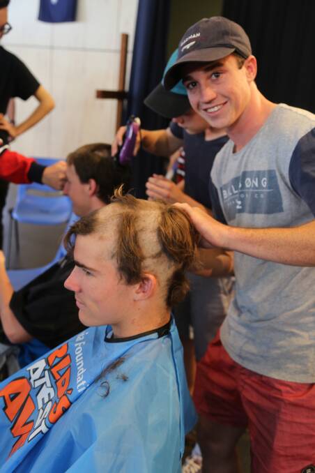 SKILLS: Sam Buster looks happy with his hairdressing skills during the World's Greatest Shave.