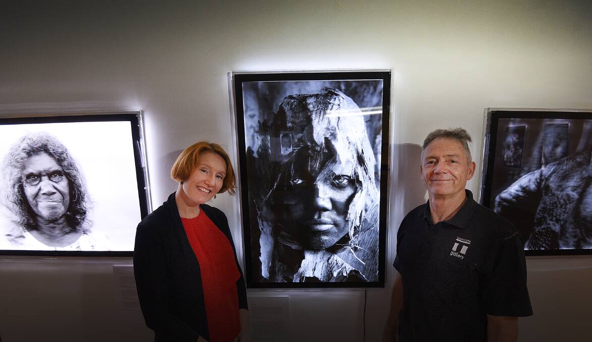 ICONIC: Gallery director Bridget Guthrie and staff member Brian Bernays with one of the artworks on exhibition. Photo: Gareth Gardner 140217GGA03