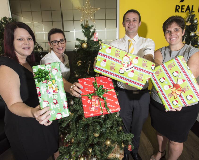 GIFT OF GIVING: Ray White's Natalie Taylor, Maddy Lang, Shane Turner and Linda Brooker are digging deep to help those less fortunate this Christmas season. Photo: Peter Hardin 091216PHA15