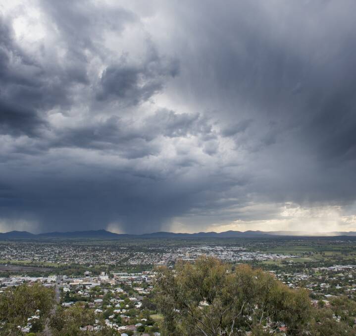 PASSING THROUGH: The view from the Tamworth Lookout as a storm front passes over the city. Photo: Peter Hardin 271016PHE08