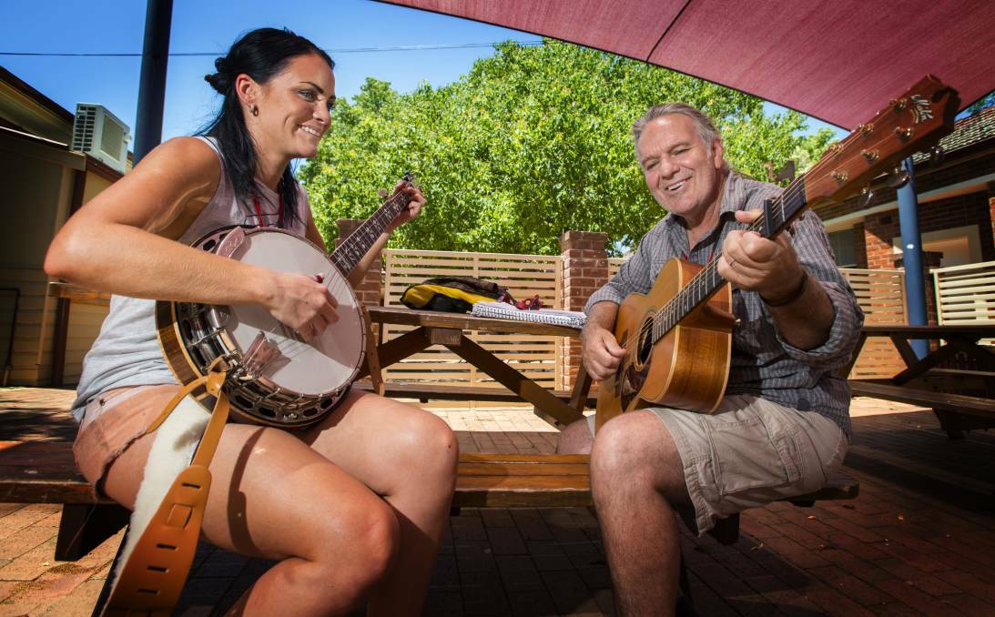 STRUMMING: 2016 student Matilda Sommers with tutor Kevin Bennett at the CMAA Academy of Country Music at Calrossy. Photo: Peter Hardin 080117PHB010