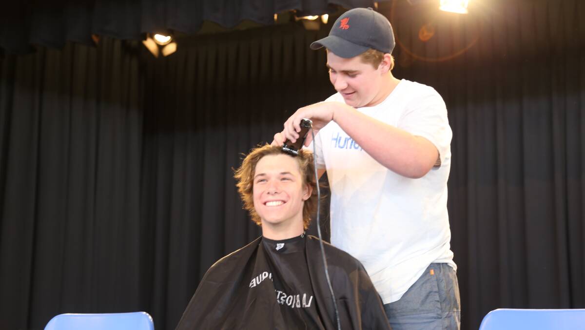 FUN AND GAMES: Zac Hatton took great pleasure in shaving a z into the head of Ross Job.