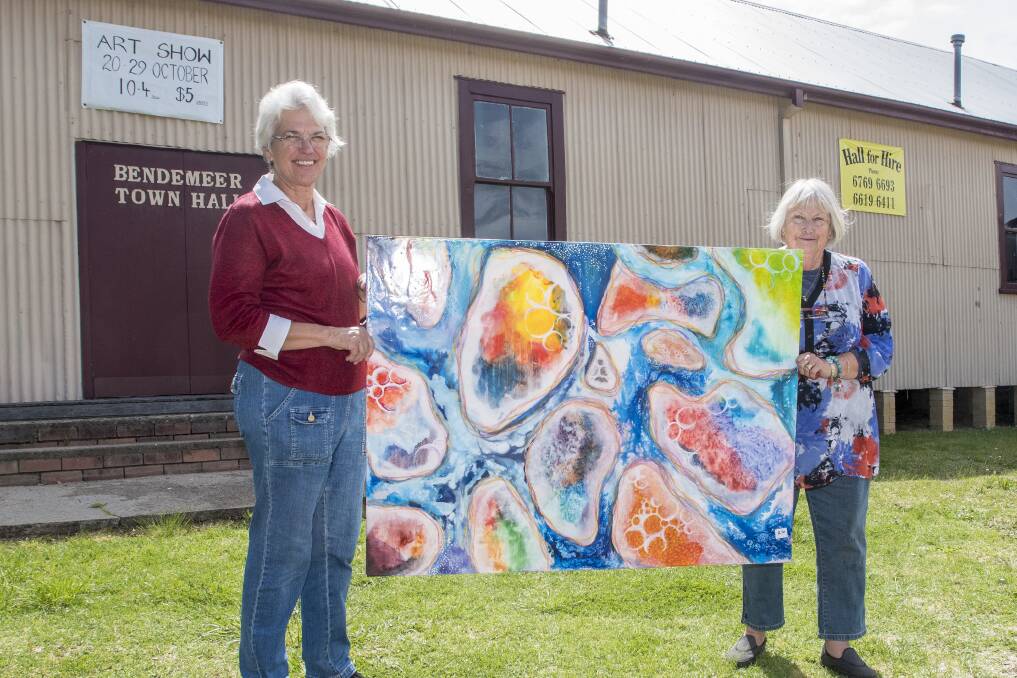 CREATIVE: Carolann Brown and Margaret Hemmings with a painting by Sharna Tapp of Calrossy. Photo: Peter Hardin 161017PHD008