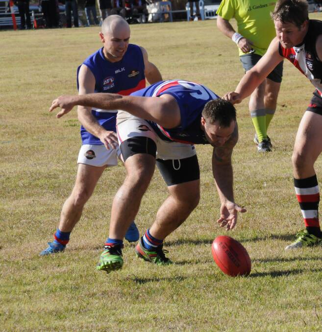 HUNTING FOR THE BALL: Matthew Pengilly leads the chase for the ball as he reaches to field it for the Gunnedah Bulldogs AFC against the Inverell Saints.