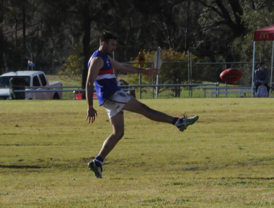 FINDING A TARGET: Alistair Hillard kicks to a team-mate in last Saturday's Tamworth AFL match at Inverell. Hillard was among Gunnedah's best in its victory which ended the Inverell Saints' season.
