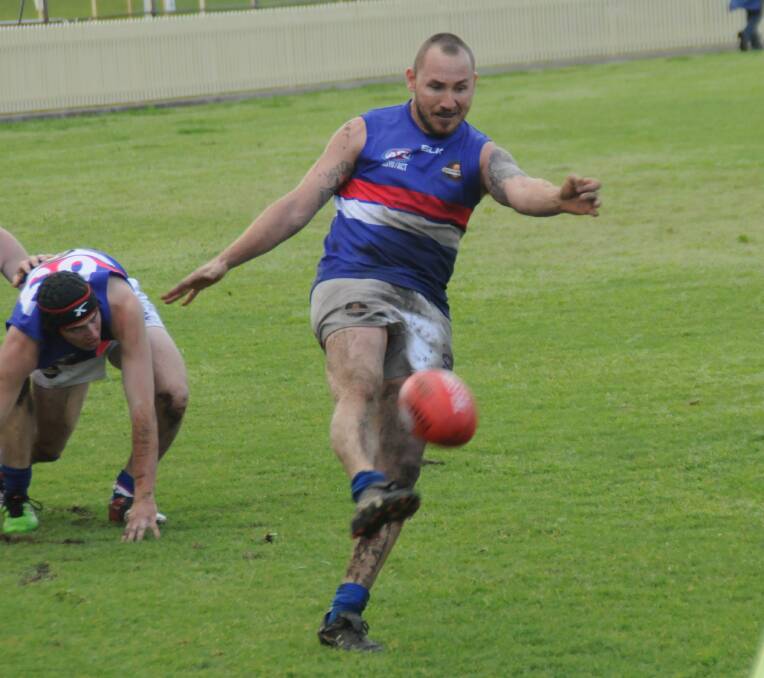 LET'S GET OUT OF HERE: Brad Jenkinson seeks to kick the Gunnedah Bulldogs AFC out of their own territory during Saturday's preliminary final at Tamworth.