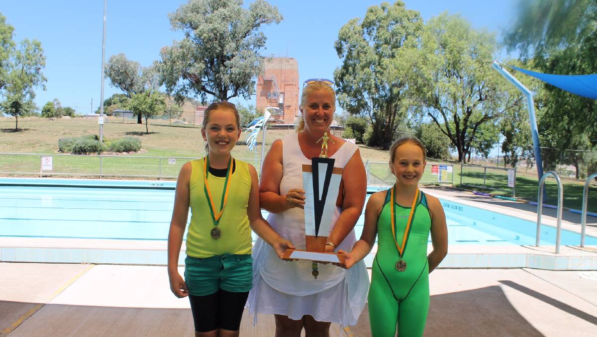 Mrs Kelly Barwick presents the N&K Barwick trophy with house captains Bella McCarthy & Katie Martin accepting on behalf of Banksia.