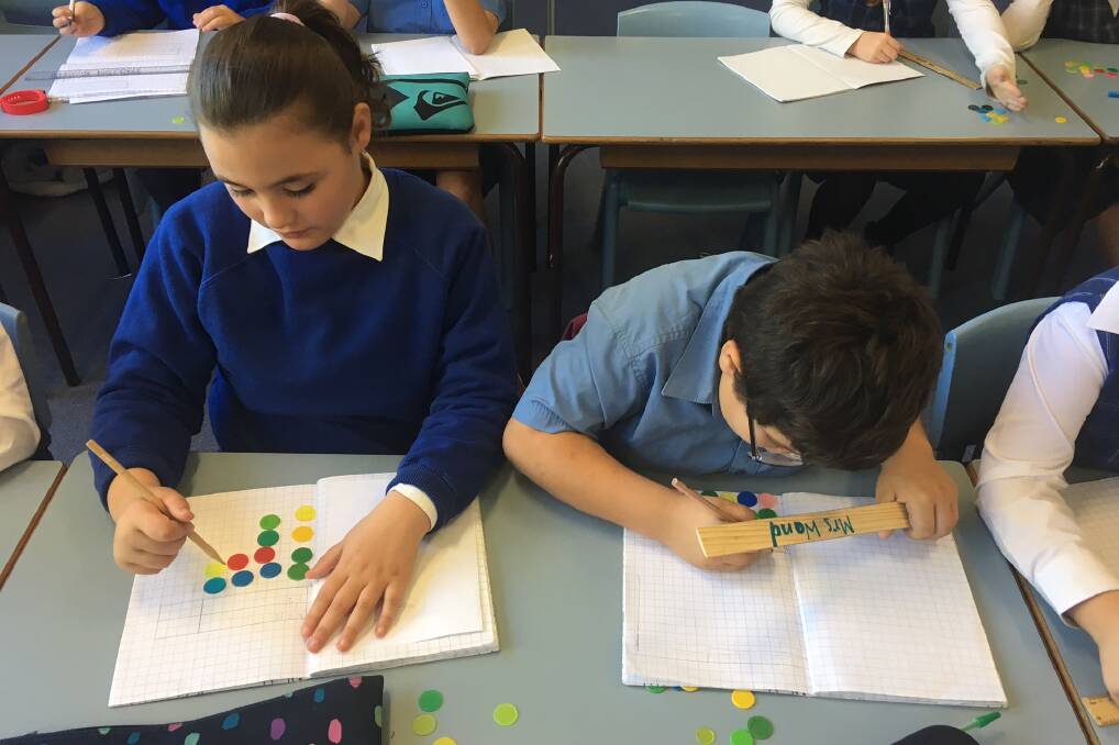 Werris Creek's Taniell Anderson-Frewen and Matthew Piper working with counters in maths.