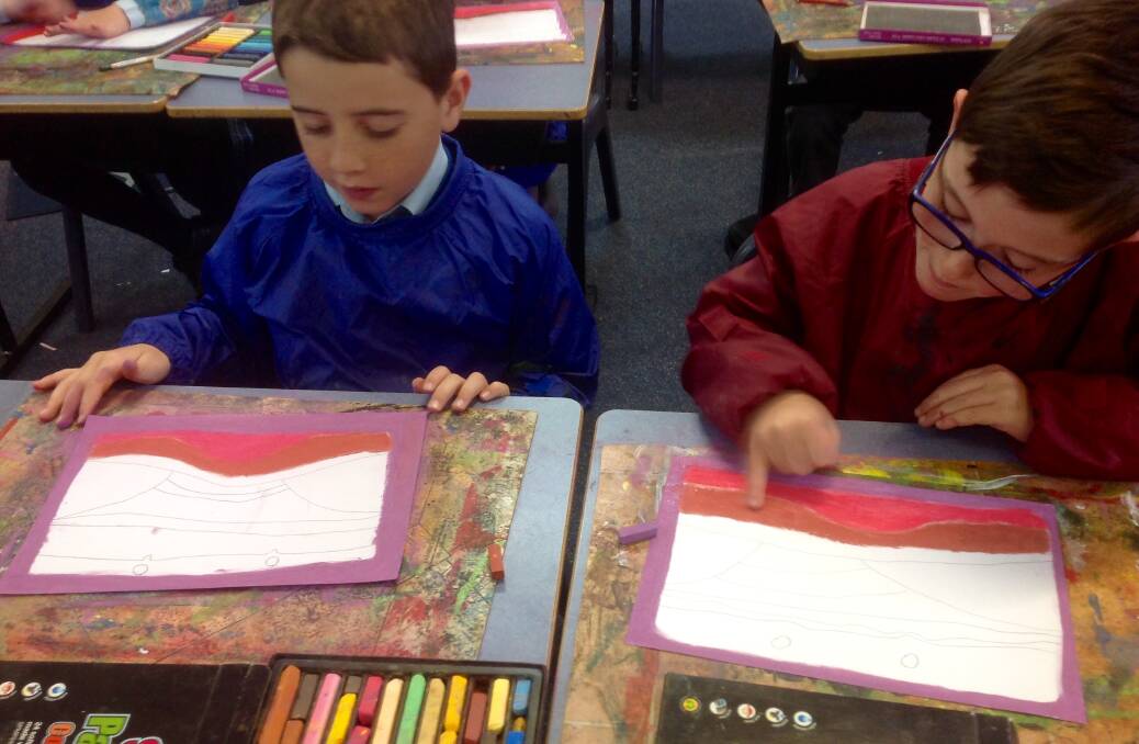 St Edward's students Dylan Mihell and Jack Gaynor of 2B using soft pastels to recreate the work of artist Sally Morgan in visual arts lesson.