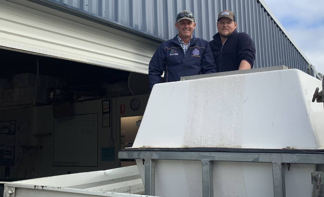 SPECIAL CARGO: Bathurst High technological and applied studies head teacher Patrick Ford and hatchery manager from Gaden Trout Hatchery Mitch Elkins during the trout transport. Photo: SUPPLIED