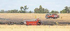 Tragic crash: Emergency personnel secure the crash site in a paddock just outside Tamworth.