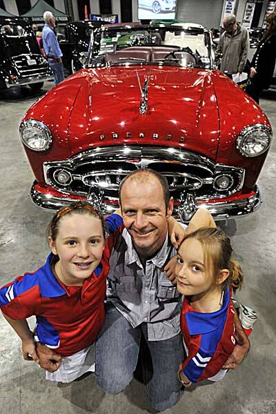 FAMILY TIME: From left, Heather, Will and Phoebe Witts from Tamworth checking out the bright red Packard. Photo: Barry Smith 050512BSD12
