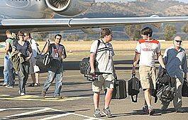 Faster than a speeding bullet: Brandon Routh (pictured second from right) touches down at Tamworth Airport with fellow Superman Returns cast and crew yesterday. Photo: Barry Smith