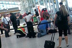 Airport staff and members of the public try to revive Anthony Zervas.