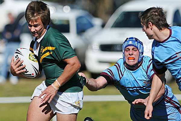Farrer centre Kyle Avery can’t escape the clutches of St Greg’s lock Adam Elliott in yesterday’s GIO Schoolboys Cup clash at John Simpson Oval, Farrer. Avery scored Farrer’s only try in the 18-8 loss. Photo: Barry Smith 210612BSC23