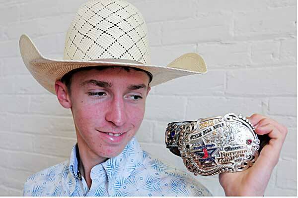 15-year-old Tamworth bullrider Bradie Gray shows off his reserve champion buckle from his trip to the high schools rodeo finals in America. Photo: Rob Chappel 090712RCC08