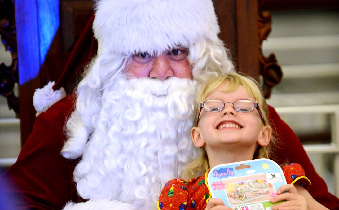 WISHES: Four-year-old Tilly Baily with Santa at Shoppingworld yesterday. Photo: Barry Smith  101213BSA23