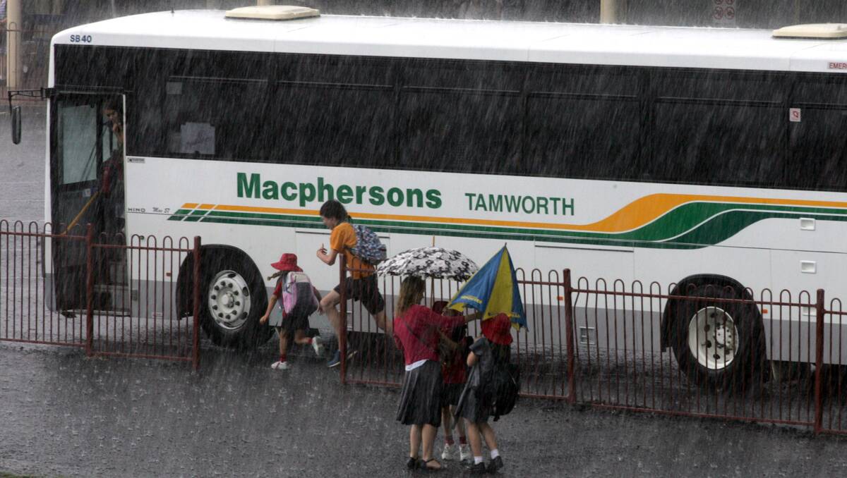 School children race to beat the storm yesterday in Tamworth. Photo: Kitty Hill