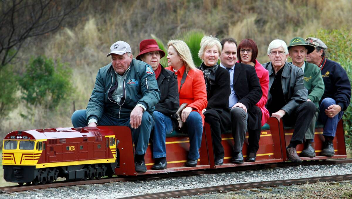 ALL ABOARD: The Singh family and model train fans at the Oxley Loop opening. From left, Gordon and Jill Laidlaw, Janelle Singh, Gwen Singh, Bryan and Helen Singh, Warren Woodley, David Scott and Brian Carter.  150613GGB16