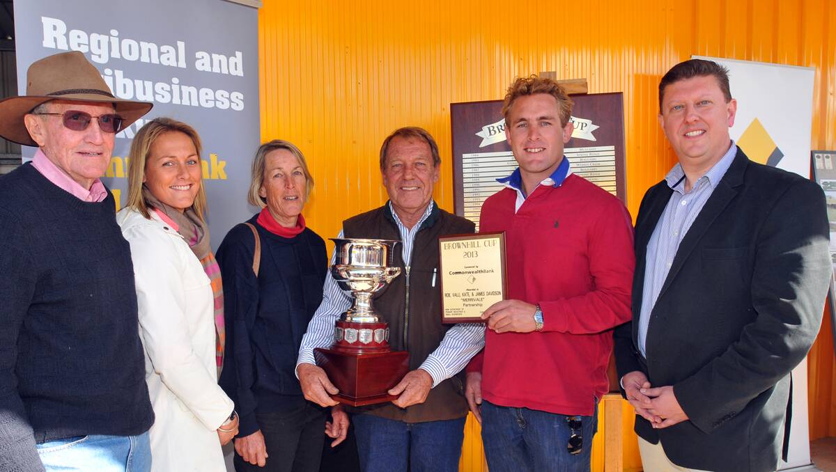 BROWNHILL CUP WINNERS: David Brownhill, left, was on hand to see the prestigious Brownhill Cup awarded to Kate, Valli, Rob and James Davidson at AgQuip yesterday by Commonwealth Bank Regional and Agribusiness Banking executive general manager Geoff Wearne. Photos: Geoff O’Neill 210813GOA22