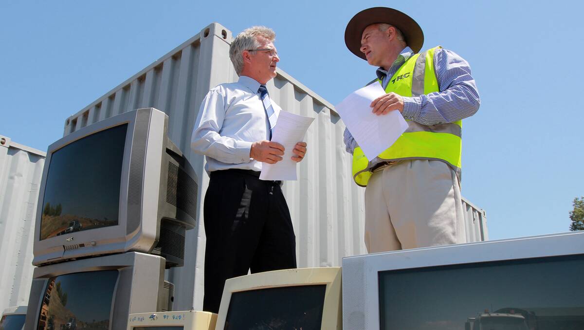 dump responsibly: Council,s waste services manager Jonathan Beckett, right, and Mark Chew, manager of e-waste from Joblink Plus, are reminding the public to dispose of analogue televisions at Tamworth’s waste facility. 311012RCC03