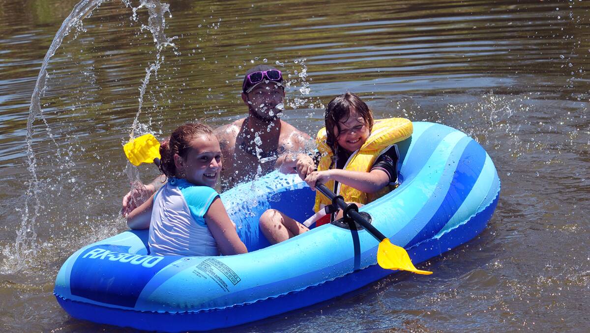 BEAT THE HEAT: From left, Jessamie Lamey, Kevin Russell and Bella Russell found a place to cool off in the Peel River at Jewry St in Tamworth. It’s likely to become a popular spot over the next week. Photo: Geoff O’Neill 060113GOD02