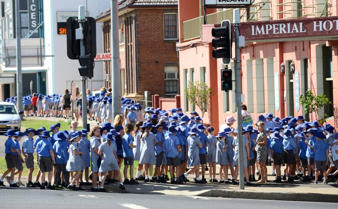 SEA OF HATS: An army of Tamworth Public School students stopped traffic at Brisbane and Marius streets yesterday. Photo: Barry Smith 1111213BSB05