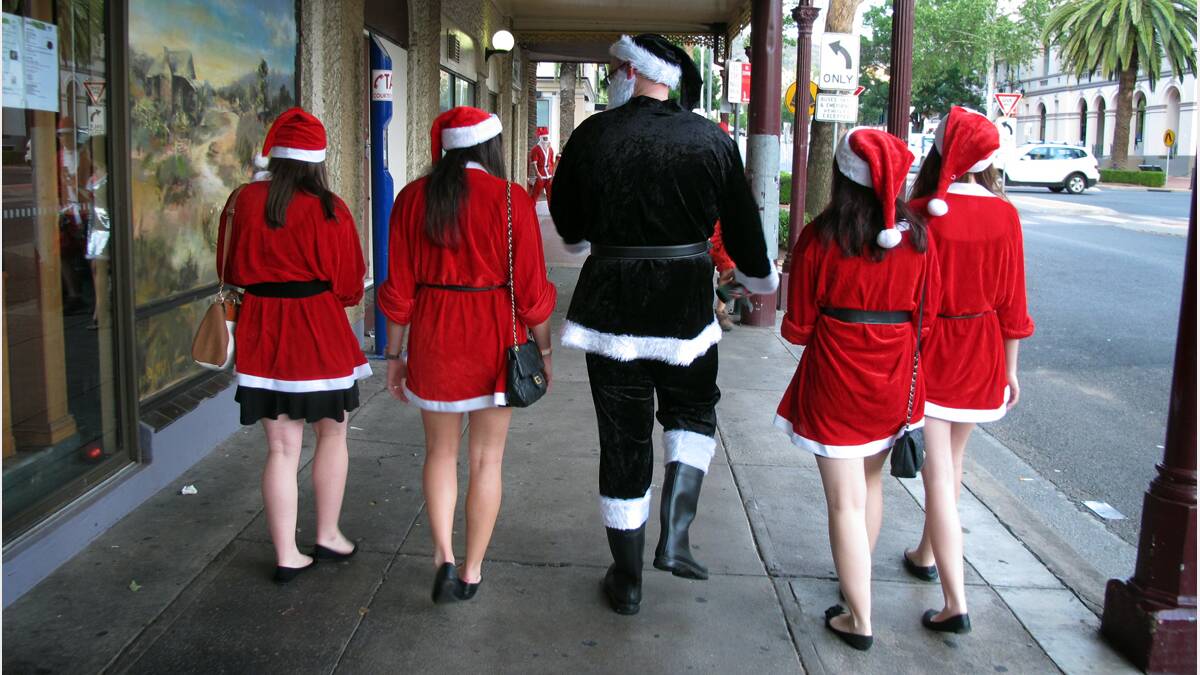 How you doin'? Black Santa tries his hand with some of Santa's little helpers. Photo: Kitty Hill