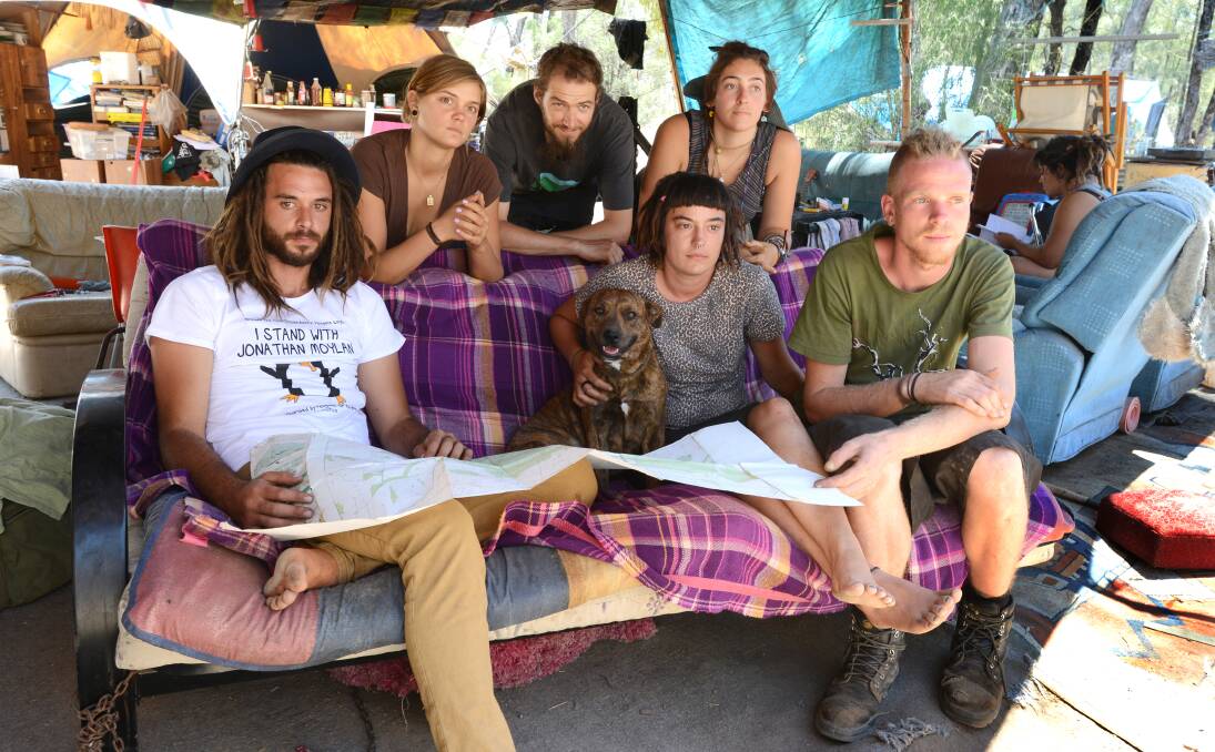 RESOLUTE: Protesters camped out in the Leard State Forest hope to generate enough community support to force Whitehaven Coal to abandon its plans for an open-cut coalmine near Boggabri. Front from left, Jared Bishop, Danielle Hellyer and Simon Outhred. Bac­­­­k, Hailey Sarah, Glenn Todd and Helen War study a map of the area in preparation for their next protest.  Photo: Barry Smith 191213BSD03