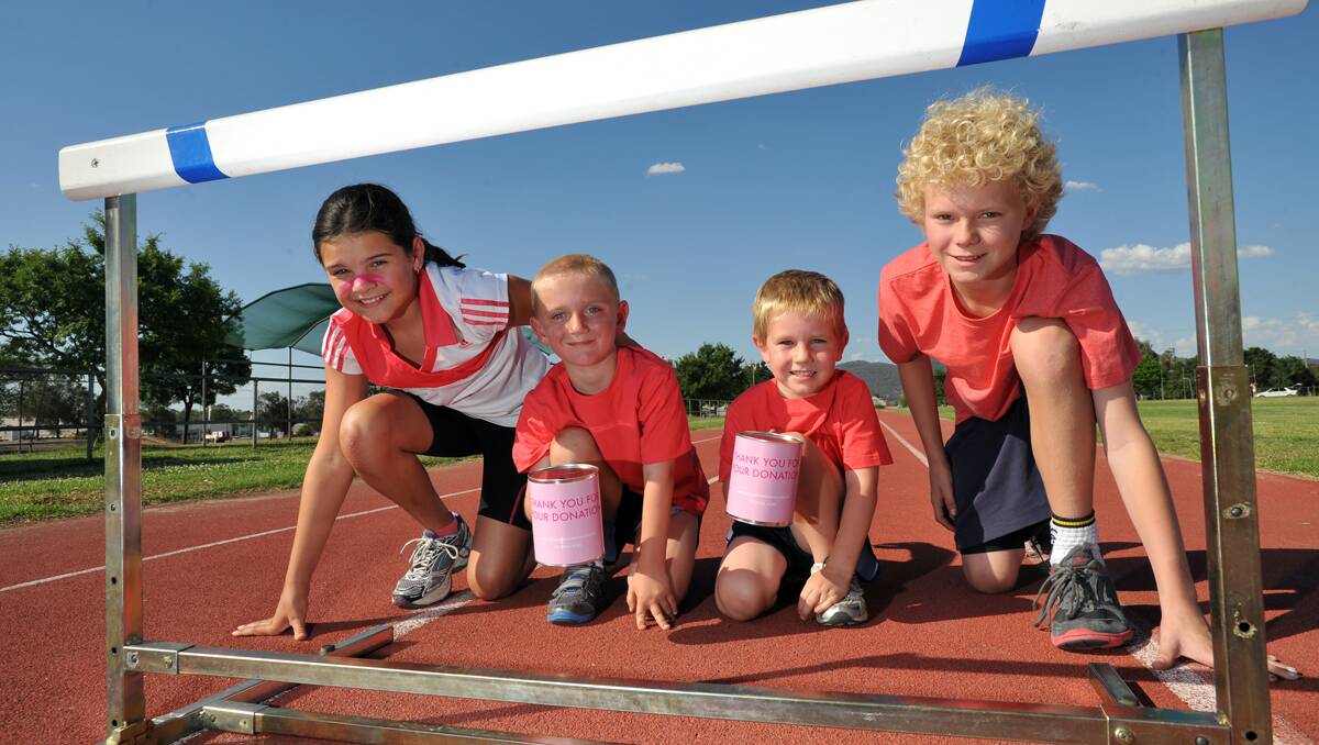 Tamworth Little Athletics is raising money for the McGrath Foundation for the first time ever during its annual gala day for 2012. Emma Klasen  (left, 10), Isaac (7) and Luke (6) Fensbo and Ryan Schmiedel (13) can’t wait to hit the track. Photo: Barry Smith 131112BSD01