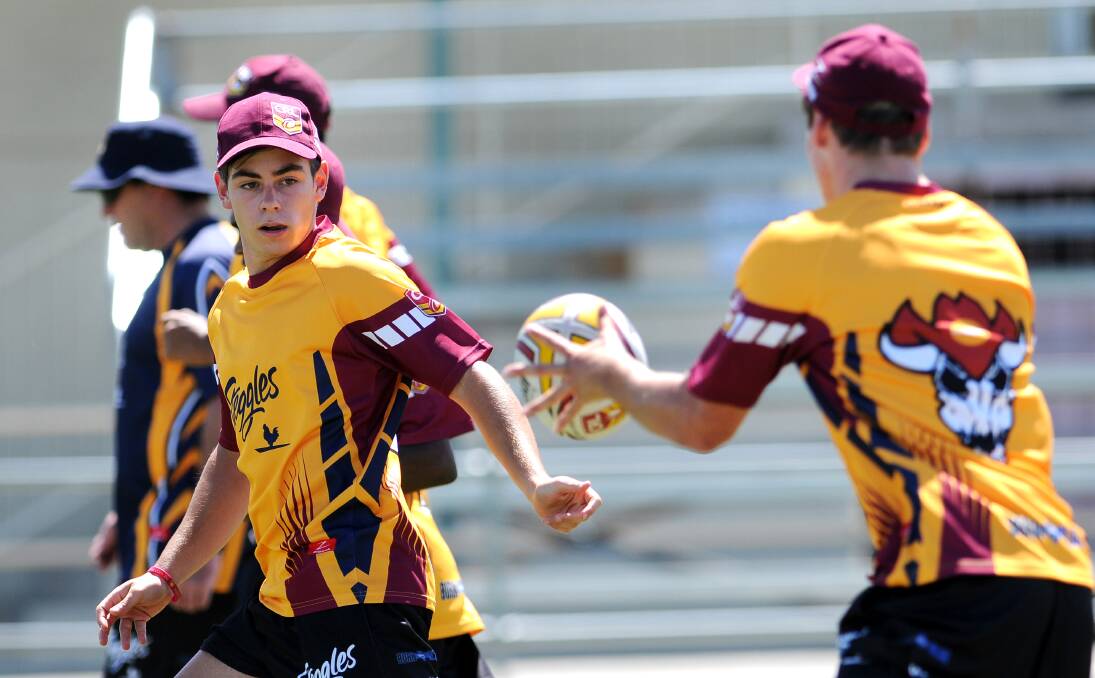 Singleton's Zac Taylor offloads during a passing drill at Scully Park on Saturday.   141213BSE33