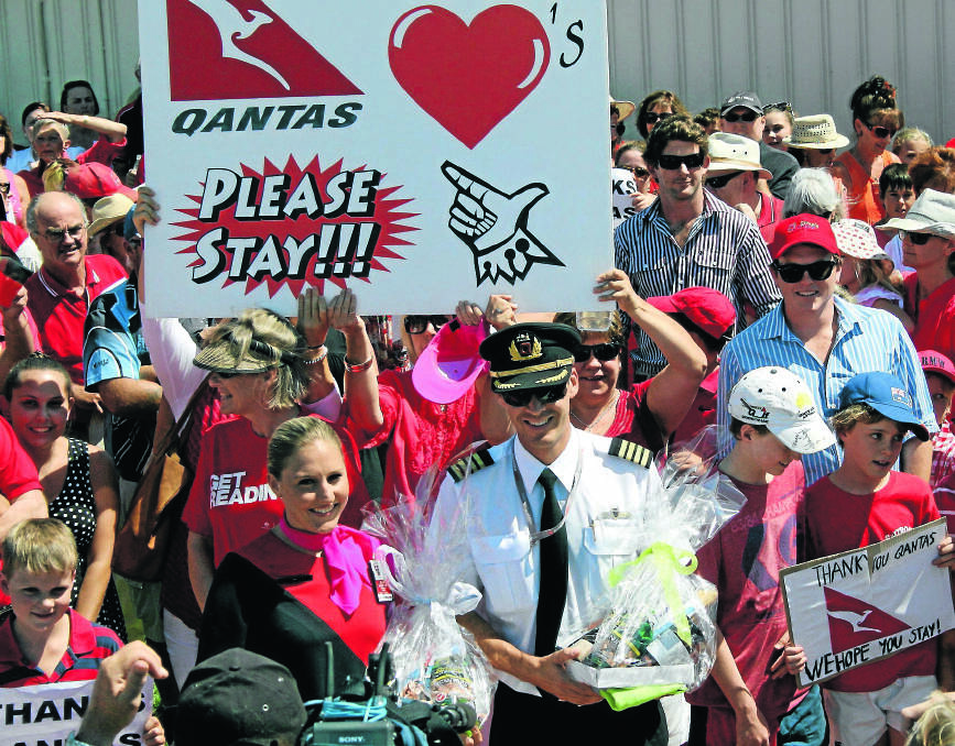 SHOW OF THANKS: QantasLink flight attendant Jen Rendy and captain Rob Langfield are thrilled to accept gifts on behalf of the whole airline at a public rally in Moree yesterday. Photo: Bill Poulos